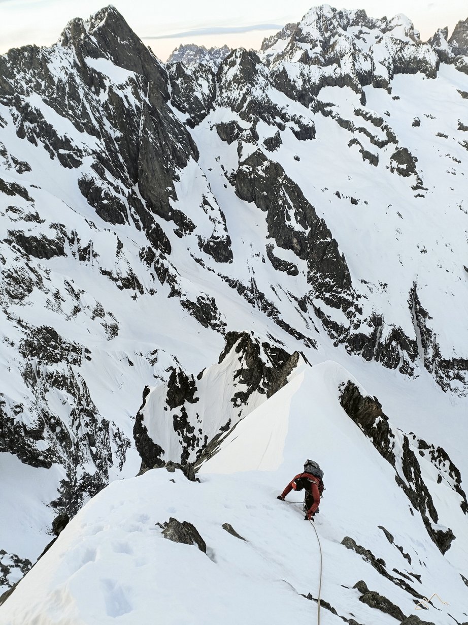 Alpinista impegnato su una via di ghiaccio e misto