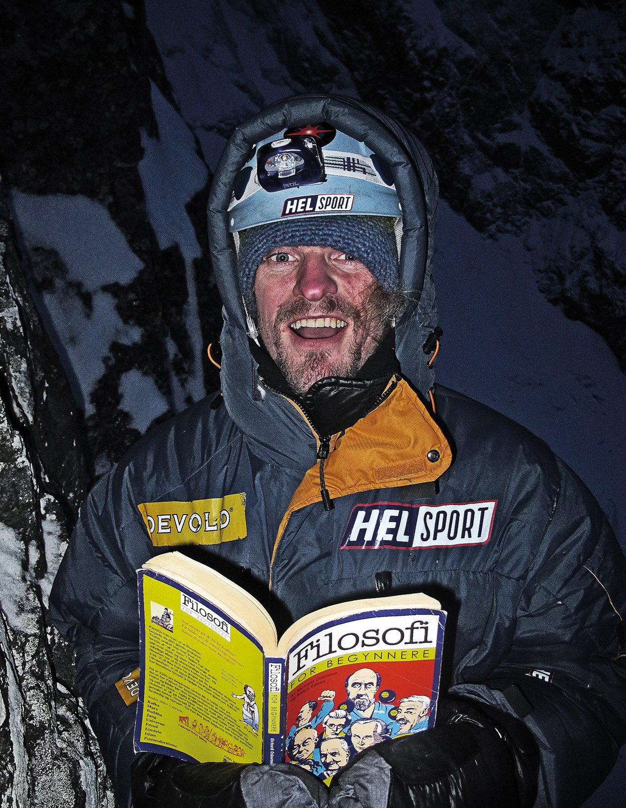alpinista in bivacco con un libro