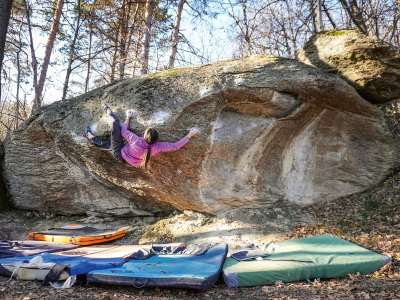 ragazza arrampicata su un duro boulder